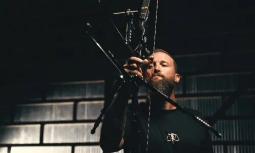 Extrait du clip où Guillaume Toucoullet tire à l’arc avec un bras et sa bouche.