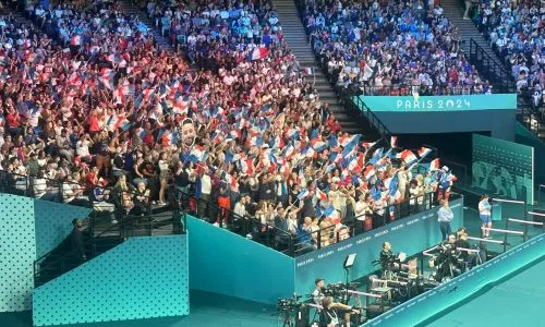 Des milliers de supporters français agitent des drapeaux dans les tribunes.